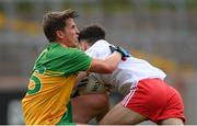 15 May 2021; Peadar Mogan of Donegal tackled Darragh Canavan of Tyrone during the Allianz Football League Division 1 North Round 1 match between Tyrone and Donegal at Healy Park in Omagh, Tyrone. Photo by Stephen McCarthy/Sportsfile