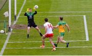 15 May 2021; Conor McKenna of Tyrone has a shot on Donegal goalkeeper Shaun Patton while being tracked by Neil McGee, right, during the Allianz Football League Division 1 North Round 1 match between Tyrone and Donegal at Healy Park in Omagh, Tyrone. Photo by Stephen McCarthy/Sportsfile
