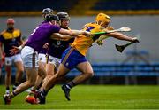 16 May 2021; Mark Rogers of Clare is tackled by Diarmuid O'Keeffe, left, and Joe O'Connor of Wexford during the Allianz Hurling League Division 1 Group B Round 2 match between Clare and Wexford at Cusack Park in Ennis, Clare. Photo by Ray McManus/Sportsfile