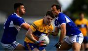 16 May 2021; Gavin Cooney of Clare is tackled by Laois players Robert Pigott and Gareth Dillon during the Allianz Football League Division 2 South Round 1 match between Clare and Laois at Cusack Park in Ennis, Clare. Photo by Ray McManus/Sportsfile