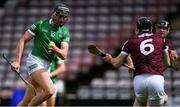 16 May 2021; Gearóid Hegarty of Limerick handpasses the ball as Padraic Mannion of Galway closes in during the Allianz Hurling League Division 1 Group A Round 2 match between Galway and Limerick at Pearse Stadium in Galway. Photo by Piaras Ó Mídheach/Sportsfile