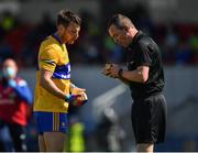 16 May 2021; Referee Sean Lonnergan speaks to Eoghan Collins of Clare before issuing him a yellow card during the Allianz Football League Division 2 South Round 1 match between Clare and Laois at Cusack Park in Ennis, Clare. Photo by Ray McManus/Sportsfile