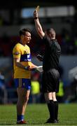 16 May 2021; Referee Sean Lonnergan issues a yellow card to Eoghan Collins of Clare during the Allianz Football League Division 2 South Round 1 match between Clare and Laois at Cusack Park in Ennis, Clare. Photo by Ray McManus/Sportsfile