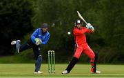 20 May 2021; Greg Ford of Munster Reds plays a shot watched by Leinster Lightning wicketkeeper Lorcan Tucker during the Cricket Ireland InterProvincial Cup 2021 match between Leinster Lightning and Munster Reds at Pembroke Cricket Club in Dublin. Photo by Matt Browne/Sportsfile