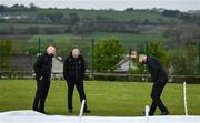 21 May 2021; Match referee Graham McCrea, centre, and Umpires Roland Black, right, and Alan Neill inspect the pitch after play was delayed before the Cricket Ireland InterProvincial Cup 2021 match between North West Warriors and Northern Knights at Bready Cricket Club in Magheramason, Tyrone. Photo by Sam Barnes/Sportsfile
