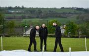 21 May 2021; Match referee Graham McCrea, centre, and Umpires Roland Black, right, and Alan Neill inspect the pitch after play was delayed before the Cricket Ireland InterProvincial Cup 2021 match between North West Warriors and Northern Knights at Bready Cricket Club in Magheramason, Tyrone. Photo by Sam Barnes/Sportsfile