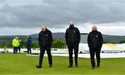 21 May 2021; Match referee Graham McCrea, left, and Umpires Roland Black, centre, and Alan Neill, right, return to the club house after conducting a pitch inspection after play was delayed before the Cricket Ireland InterProvincial Cup 2021 match between North West Warriors and Northern Knights at Bready Cricket Club in Magheramason, Tyrone. Photo by Sam Barnes/Sportsfile