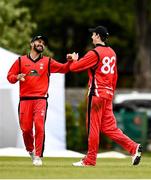 22 May 2021; Greg Ford of Munster Reds celebrates with team-mate Amish Sidhu after catching out Kevin O'Brien of Leinster Lighting during the Cricket Ireland InterProvincial Cup 2021 match between Munster Reds and Leinster Lightning at Pembroke Cricket Club in Dublin. Photo by Harry Murphy/Sportsfile