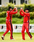 22 May 2021; Seamus Lynch of Munster Reds, right, celebrates with team-mate Joshya Manley after taking the wicket of Jamie Grassi of Leinster Lightning during the Cricket Ireland InterProvincial Cup 2021 match between Munster Reds and Leinster Lightning at Pembroke Cricket Club in Dublin. Photo by Harry Murphy/Sportsfile