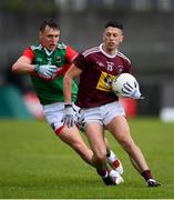 22 May 2021; Ronan O'Toole of Westmeath in action against Michael Plunkett of Mayo during the Allianz Football League Division 2 North Round 2 match between Westmeath and Mayo at TEG Cusack Park in Mullingar, Westmeath. Photo by Stephen McCarthy/Sportsfile