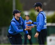 22 May 2021; George Dockrell of Leinster Lighting, left, celebrates with team-mate Andy Balbirnie after catching out Amish Sidhu of Munster Reds during the Cricket Ireland InterProvincial Cup 2021 match between Munster Reds and Leinster Lightning at Pembroke Cricket Club in Dublin. Photo by Harry Murphy/Sportsfile