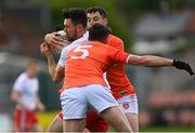 22 May 2021; Conor McKenna of Tyrone is tackled by Connaire Mackin, 5, and Aaron McKay of Armagh during the Allianz Football League Division 1 North Round 2 match between Armagh and Tyrone at Athletic Grounds in Armagh. Photo by Ramsey Cardy/Sportsfile