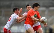 22 May 2021; James Morgan of Armagh is tackled by Darragh Canavan, left, and Conor McKenna of Tyrone during the Allianz Football League Division 1 North Round 2 match between Armagh and Tyrone at Athletic Grounds in Armagh. Photo by Ramsey Cardy/Sportsfile