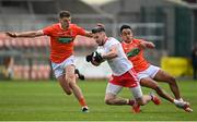 22 May 2021; Matthew Donnelly of Tyrone in action against Aaron McKay, left, and Jemar Hall of Armagh during the Allianz Football League Division 1 North Round 2 match between Armagh and Tyrone at Athletic Grounds in Armagh. Photo by Ramsey Cardy/Sportsfile