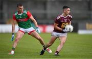 22 May 2021; Ronan O'Toole of Westmeath in action against Michael Plunkett of Mayo during the Allianz Football League Division 2 North Round 2 match between Westmeath and Mayo at TEG Cusack Park in Mullingar, Westmeath. Photo by Stephen McCarthy/Sportsfile