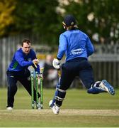 25 May 2021; Andy McBrine of North West Warriors knocks the bails off the stumps to put out Jamie Grassi of Leinster Lightning during the Cricket Ireland InterProvincial Cup 2021 match between North West Warriors and Leinster Lightning at Eglinton Cricket Club in Derry. Photo by David Fitzgerald/Sportsfile
