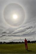 27 May 2021; Aaron Cawley of Munster Reds looks on as a sun halo appears in the sky during the Cricket Ireland InterProvincial Cup 2021 match between Munster Reds and Northern Knights at Pembroke Cricket Club in Dublin. Photo by Harry Murphy/Sportsfile