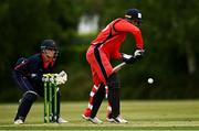 27 May 2021; Murray Commins of Munster Reds bats as wicketkeeper Neil Rock of Northern Knights looks on during the Cricket Ireland InterProvincial Cup 2021 match between Munster Reds and Northern Knights at Pembroke Cricket Club in Dublin. Photo by Harry Murphy/Sportsfile