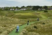 27 May 2021; Golfers walk to the 16th fairway during day one of the Irish Challenge Golf at Portmarnock Golf Links in Dublin. Photo by Ramsey Cardy/Sportsfile