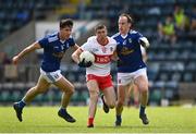 29 May 2021; Ciaran McFaul of Derry is tackled by Martin Reilly, right, and Killian Brady of Cavan during the Allianz Football League Division 3 North Round 3 match between Cavan and Derry at Kingspan Breffni in Cavan. Photo by Harry Murphy/Sportsfile