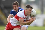 29 May 2021; Shane McGuigan of Derry in action against Cillian Clarke of Cavan during the Allianz Football League Division 3 North Round 3 match between Cavan and Derry at Kingspan Breffni in Cavan. Photo by Harry Murphy/Sportsfile
