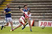29 May 2021; Gareth McKinless of Derry has a shot on goal despite the attention of Luke Fortune of Cavan during the Allianz Football League Division 3 North Round 3 match between Cavan and Derry at Kingspan Breffni in Cavan. Photo by Harry Murphy/Sportsfile