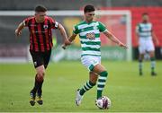 29 May 2021; Danny Mandroiu of Shamrock Rovers in action against Aaron Robinson of Longford Town during the SSE Airtricity League Premier Division match between Longford Town and Shamrock Rovers at Bishopsgate in Longford. Photo by Seb Daly/Sportsfile