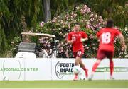 30 May 2021; A golfer stops to take in the U21 international friendly match between Switzerland and Republic of Ireland at Dama de Noche Football Centre in Marbella, Spain. Photo by Stephen McCarthy/Sportsfile