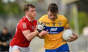 30 May 2021; Cillian Brennan of Clare in action against Cathail O'Mahony of Cork during the Allianz Football League Division 2 South Round 3 match between Clare and Cork at Cusack Park in Ennis, Clare. Photo by Harry Murphy/Sportsfile