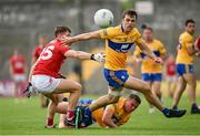 30 May 2021; Cillian Brennan of Clare in action against Cathail O'Mahony of Cork as Sean Collins of Clare looks on during the Allianz Football League Division 2 South Round 3 match between Clare and Cork at Cusack Park in Ennis, Clare. Photo by Harry Murphy/Sportsfile