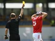 30 May 2021; Tadhg Corkery of Cork receives a yellow card from referee Seamus Mulvihill during the Allianz Football League Division 2 South Round 3 match between Clare and Cork at Cusack Park in Ennis, Clare. Photo by Harry Murphy/Sportsfile