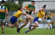 30 May 2021; David Clifford of Kerry is tackled by David Murray and Brian Stack of Roscommon  during the Allianz Football League Division 1 South Round 3 match between Roscommon and Kerry at Dr Hyde Park in Roscommon. Photo by Brendan Moran/Sportsfile