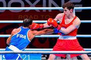 4 June 2021; Aidan Walsh of Ireland, right, and Wahid Hambli of France in their welterweight 69kg round of 16 bout on day one of the Road to Tokyo European Boxing Olympic qualifying event at Le Grand Dome in Paris, France. Photo by Baptiste Fernandez/Sportsfile