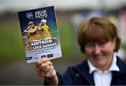 5 June 2021; Margaret Flynn, from Belfast, shows off the match programme prior to the Allianz Hurling League Division 1 Group B Round 4 match between Antrim and Wexford at Corrigan Park in Belfast. Photo by David Fitzgerald/Sportsfile