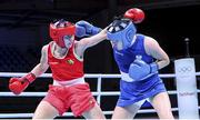 5 June 2021; Aoife O'Rourke of Ireland, left, and Elzbieta Wójcik of Poland during their middleweight 75kg quarter-final bout day two of the Road to Tokyo European Boxing Olympic qualifying event at Le Grand Dome in Paris, France. Photo by Sportsfile