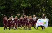 11 June 2021; Siena Lacey, right, of St. Brigid's National School holds the Daily Mile flag as her classmates run during the Daily Mile launch at St. Brigid's National School, Beechpark Lawn, Castleknock in Dublin.  Photo by Matt Browne/Sportsfile