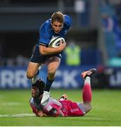 11 June 2021; Jordan Larmour of Leinster evades the tackle of Ioan Davies of Dragons during the Guinness PRO14 match between Leinster and Dragons at RDS Arena in Dublin. The game is one of the first of a number of pilot sports events over the coming weeks which are implementing guidelines set out by the Irish government to allow for the safe return of spectators to sporting events. Photo by Ramsey Cardy/Sportsfile