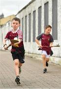 13 June 2021; Young Westmeath supporters Tom Nolan, left, age 8, and Daniel Conaty, age 7, from Collinstown, Westmeath, solo their way to the ground before the Allianz Hurling League Division 1 Group A Round 5 match between Westmeath and Limerick at TEG Cusack Park in Mullingar, Westmeath. Photo by Seb Daly/Sportsfile