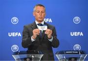 15 June 2021; UEFA head of club competitions Michael Heselschwerdt draws out the card of Shamrock Rovers during the UEFA Champions League 2021/22 First Qualifying Round draw at the UEFA headquarters in Nyon, Switzerland. Photo by Richard Juilliart / UEFA via Sportsfile