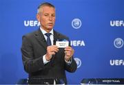 16 June 2021; UEFA head of club competitions Michael Heselschwerdt draws out the card of Slovan Bratislava or Shamrock Rovers during the UEFA Champions League 2021/22 Second Qualifying Round draw at the UEFA headquarters in Nyon, Switzerland. Photo by Richard Juilliart / UEFA via Sportsfile