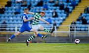 18 June 2021; Rory Gaffney of Shamrock Rovers shoots to score his side's second goal, despite pressure from Waterford's Cameron Evans, during the SSE Airtricity League Premier Division match between Waterford and Shamrock Rovers at the RSC in Waterford. Photo by Seb Daly/Sportsfile