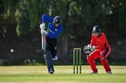 19 June 2021; Graham Kennedy of North West Warriors plays a shot, watched by Munster Reds wicketkeeper PJ Moor during the Cricket Ireland InterProvincial Trophy 2021 match between Munster Reds and North West Warriors at Pembroke Cricket Club in Dublin. Photo by Seb Daly/Sportsfile