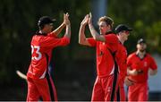 19 June 2021; Josh Manley of Munster Reds, right, is congratulated by team-mate Murray Commins after claiming the wicket of North West Warriors' Andy McBrine during the Cricket Ireland InterProvincial Trophy 2021 match between Munster Reds and North West Warriors at Pembroke Cricket Club in Dublin. Photo by Seb Daly/Sportsfile