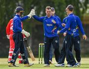 19 June 2021; Andy McBrine of North West Warriors, centre, is congratulated by team-mate Stephen Doheny, left, after claiming the wicket of Munster Reds' PJ Moor during the Cricket Ireland InterProvincial Trophy 2021 match between Munster Reds and North West Warriors at Pembroke Cricket Club in Dublin. Photo by Seb Daly/Sportsfile