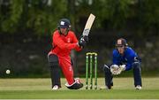19 June 2021; Murray Commins of Munster Reds plays a shot, watched by North West Warriors wicketkeeper Stephen Doheny, during the Cricket Ireland InterProvincial Trophy 2021 match between between Munster Reds and North West Warriors at Pembroke Cricket Club in Dublin. Photo by Seb Daly/Sportsfile