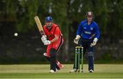 19 June 2021; Fionn Hand of Munster Reds plays a shot, watched by North West Warriors wicketkeeper Stephen Doheny, during the Cricket Ireland InterProvincial Trophy 2021 match between between Munster Reds and North West Warriors at Pembroke Cricket Club in Dublin. Photo by Seb Daly/Sportsfile