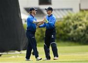 20 June 2021; Jamie Grassi of Leinster Lightning , left, celebrates a wicket with team-mate Lorcan Tucker during the Cricket Ireland InterProvincial Trophy 2021 match between Leinster Lightning and North West Warriors at Pembroke Cricket Club in Dublin. Photo by Harry Murphy/Sportsfile