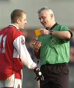 15 February 2004; Referee Seamus McGonigle issues Louth's Aaron Hoey with a yellow card. Allianz National Football League, Division 2B, Round 3, Louth v Wicklow, Pairc Mhuire, Ardee, Co. Louth. Picture credit; Ray McManus / SPORTSFILE *EDI*