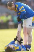 8 February 2004; Longford's Niall Sheridan relieves the cramp of team-mate David Barden. Allianz National Football League, Division 1A, Westmeath v Longford, Cusack Park, Mullingar, Co. Westmeath. Picture credit; Damien Eagers / SPORTSFILE *EDI*