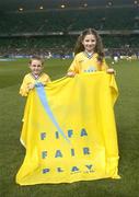 18 February 2004; Darragh Leen, aged 6, left, and Lori McHale, aged 10, from Cork, pictured as members of the Snickers Fair Play team who led the teams out before the game. International Friendly, Republic of Ireland v Brazil, Lansdowne Road. Dublin. Picture credit; Brendan Moran / SPORTSFILE *EDI*